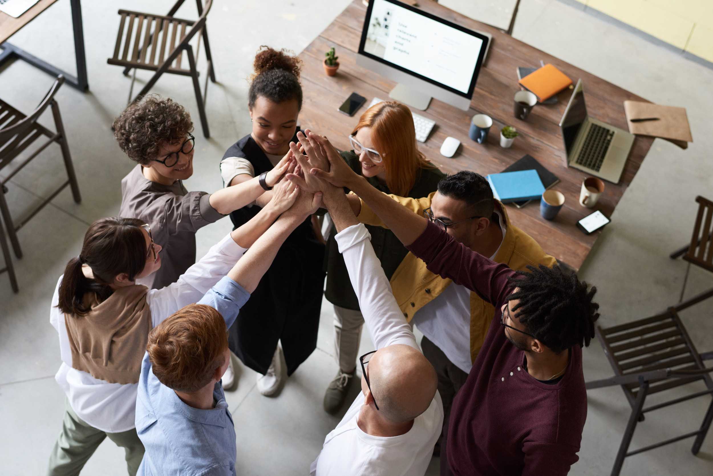 Photo of people with their hands together.